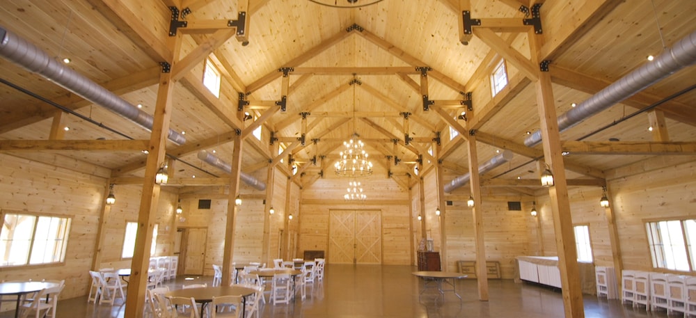 the interior of the wedding venue is lit by chandeliers