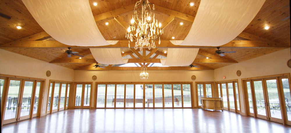 chandeliers hanging from the ceiling in the oaks wedding reception hall