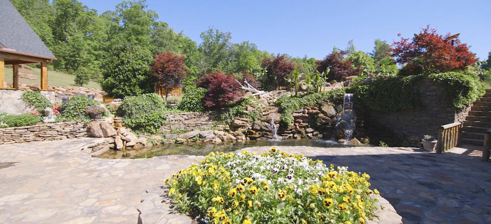 a flower bed and fountain near the ceremony location