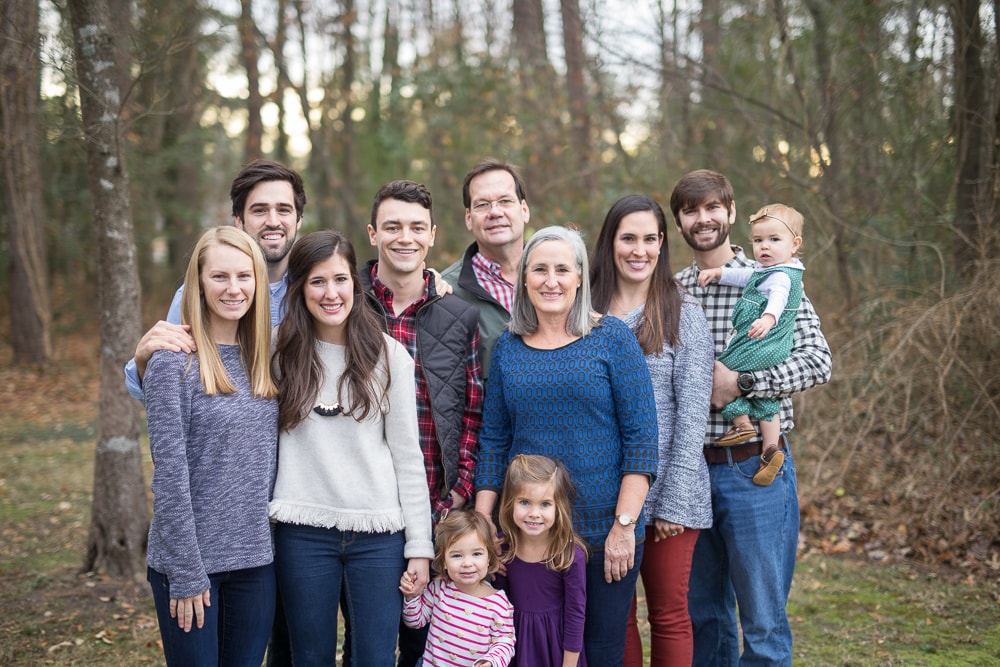 the whole family stands together for a picture