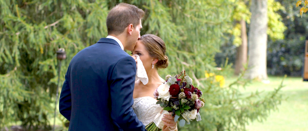 The bride dabs a tear during her first look