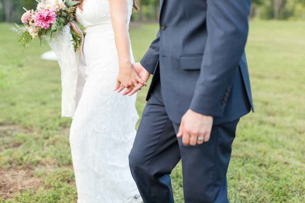 bride and groom hold hands