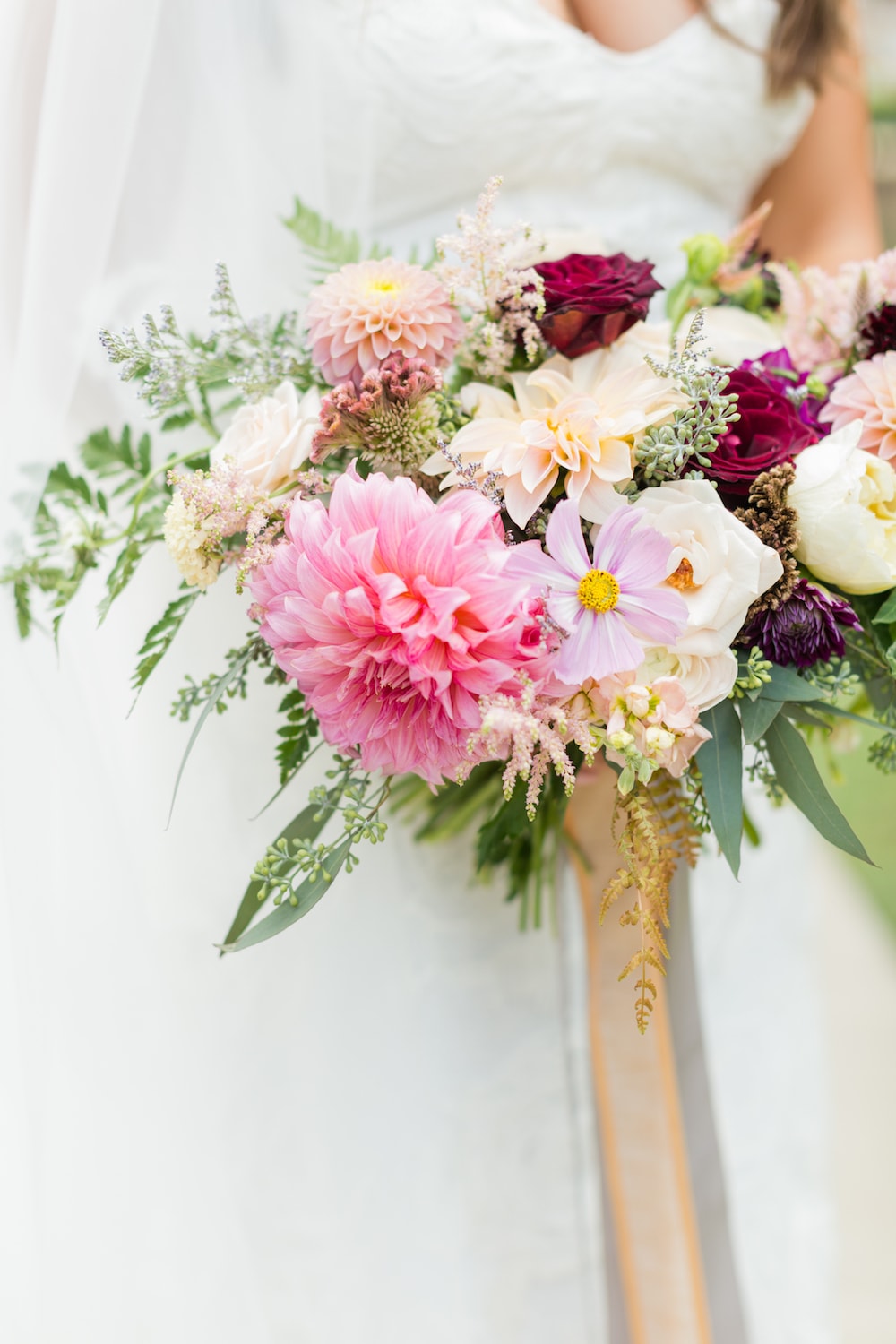 bride holds her flowers in front of her