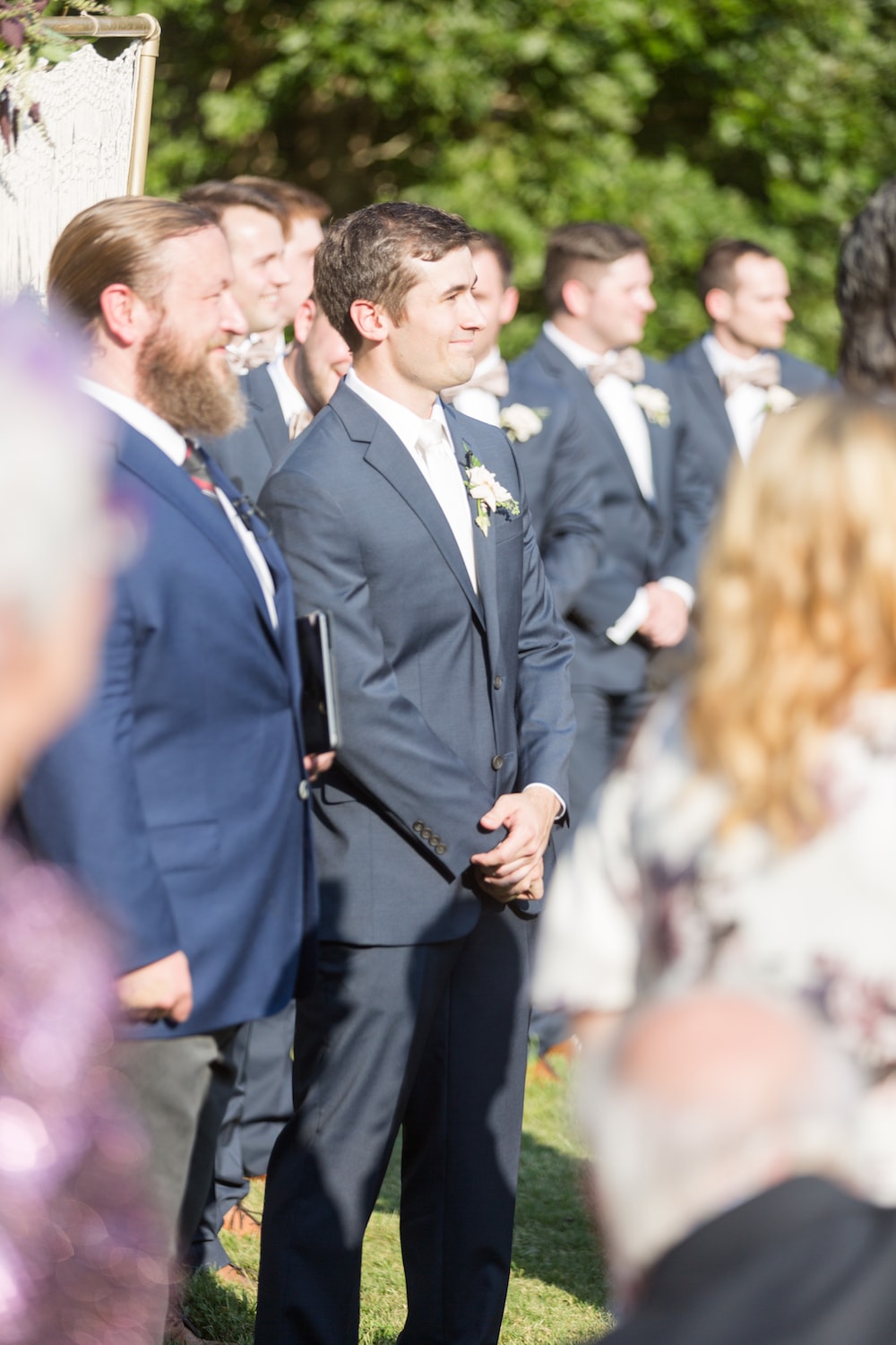 groom stands up at the front of the alter